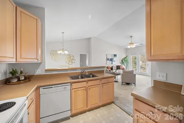 a kitchen with a sink stove and cabinets