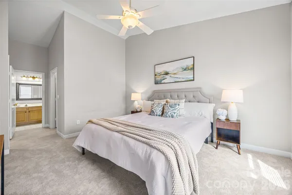 a bedroom with a bed and a chandelier