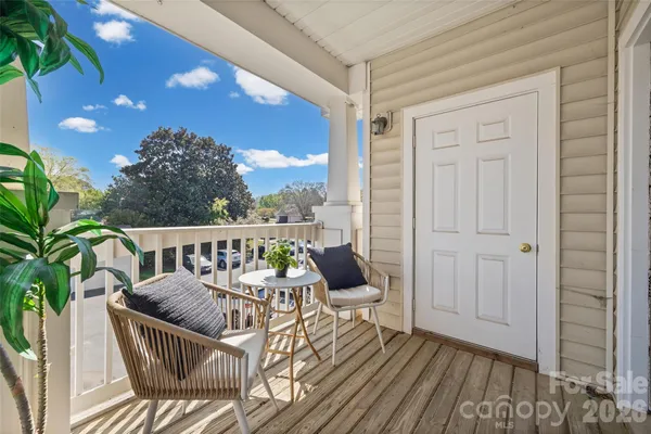 a view of a balcony with furniture