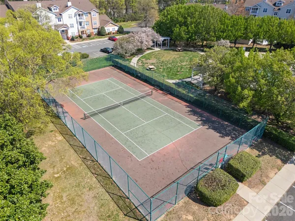 a view of a backyard with parking area