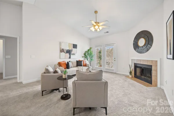 a living room with furniture a fireplace and a window