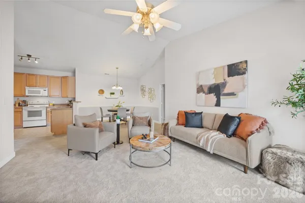 a living room with furniture and a chandelier