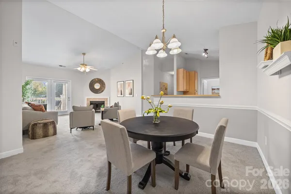 a view of a dining room with furniture and a chandelier
