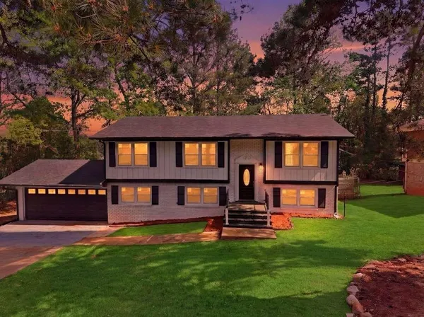 a front view of a house with swimming pool and porch
