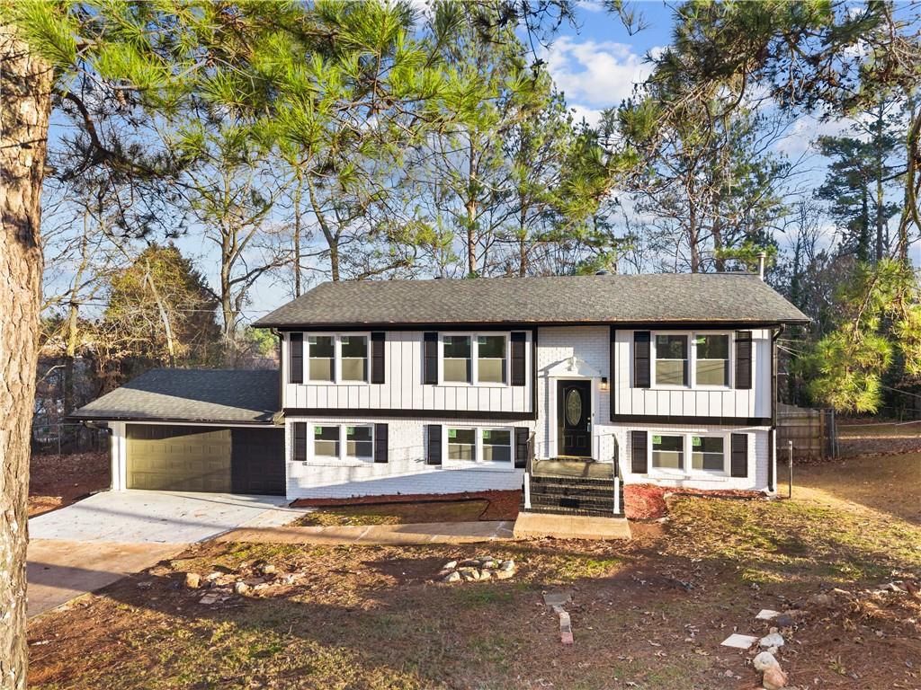 2304 South Hairston Road Decatur, GA 30035 - Photo 2 of 23 a front view of a house with a garden