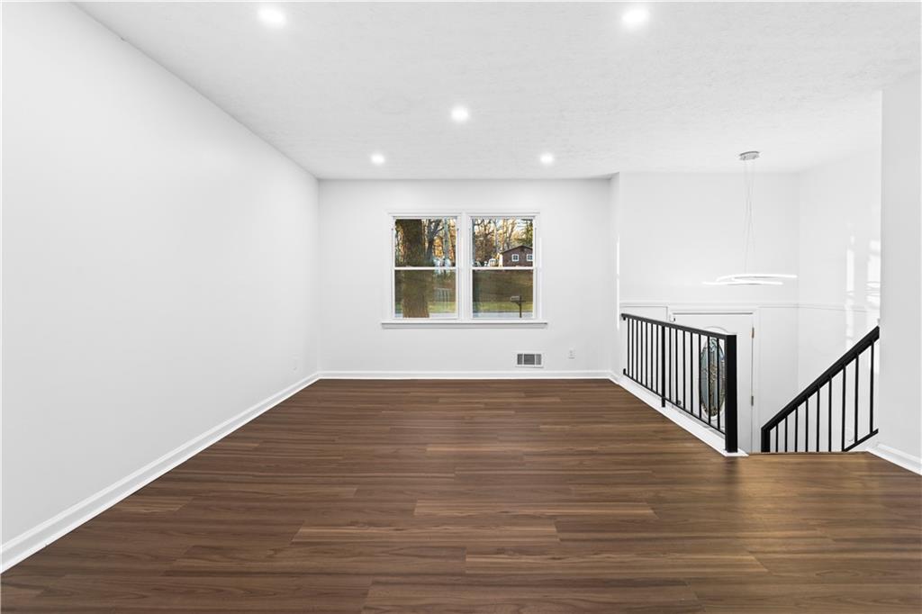 2304 South Hairston Road Decatur, GA 30035 - Photo 3 of 23 a view of a hallway with wooden floor and windows