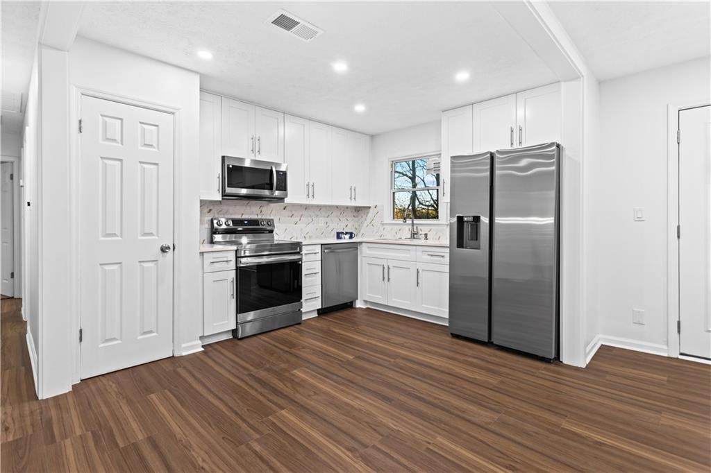 2304 South Hairston Road Decatur, GA 30035 - Photo 5 of 23 a kitchen with stainless steel appliances a refrigerator sink and microwave