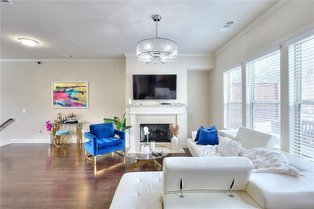 1306 Harris Way South Atlanta, GA 30319 - Photo 5 of 19 a living room with furniture a fireplace and a flat screen tv