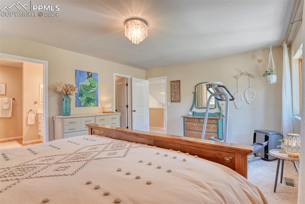 12810 Pommel Circle Elbert, CO 80106 - Photo 22 of 47 a bedroom with a large bed and a large window