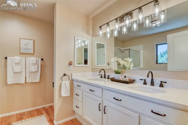 a bathroom with a sink a large mirror and vanity