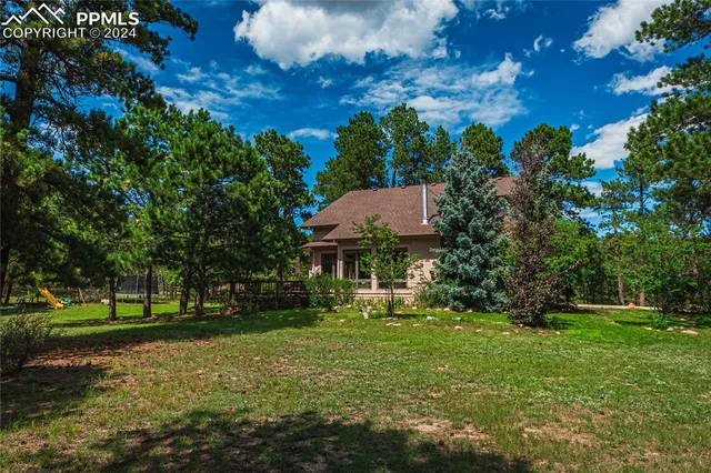 a view of a big yard with large trees