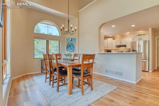 a view of a dining room with furniture window and wooden floor