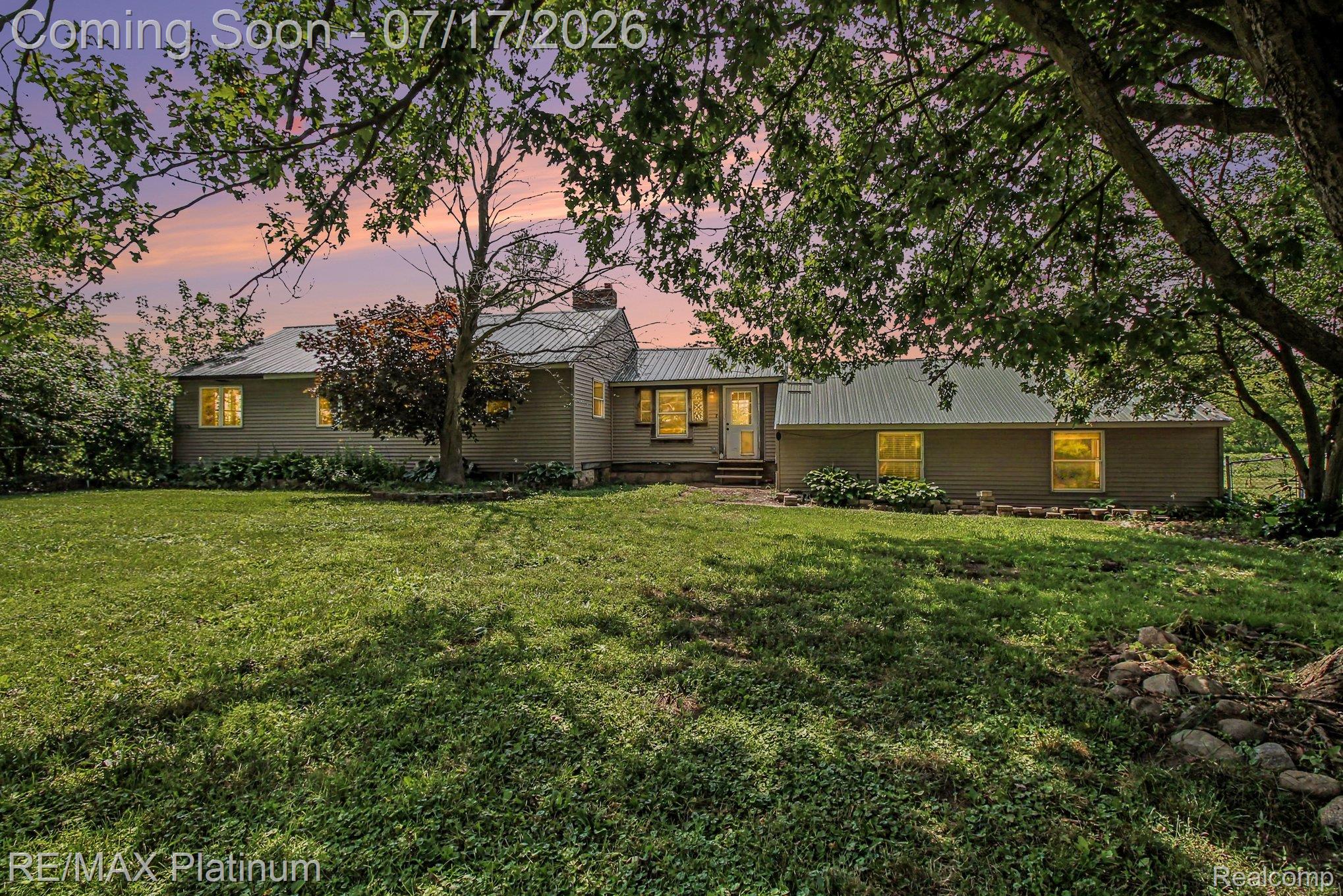 4205 Musson Road Howell, MI 48855 - Photo 1 of 23 Expansive green lawn surrounds a dwelling with a metal roof