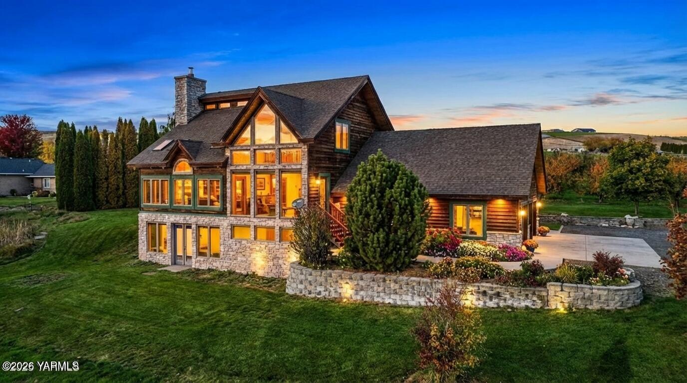 a backyard of a house with table and chairs