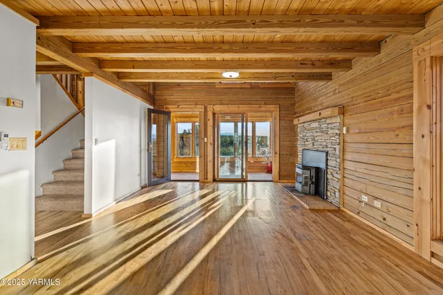 a view of a room with wooden floor and windows