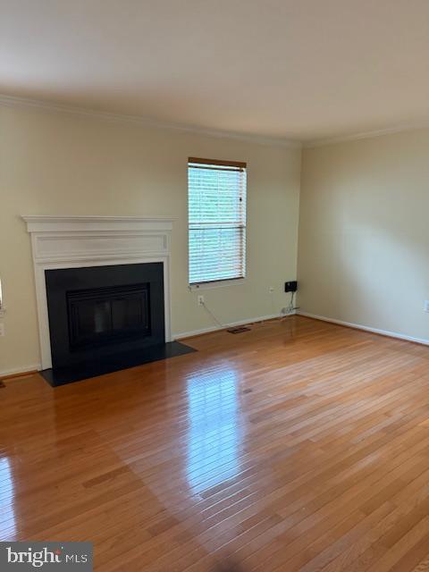 6358 Shaundale Drive Springfield, VA 22152 - Photo 13 of 54 a view of empty room with wooden floor and fireplace