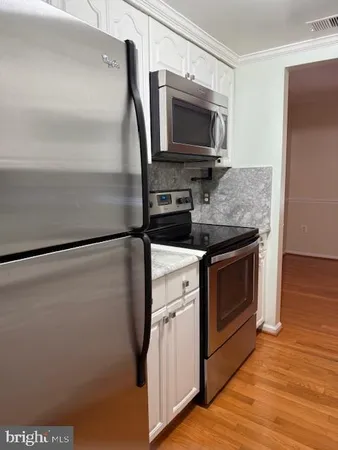 a kitchen with a stove microwave and refrigerator