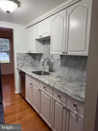 a kitchen with cabinets and window