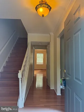 a view of entryway and hall with wooden floor