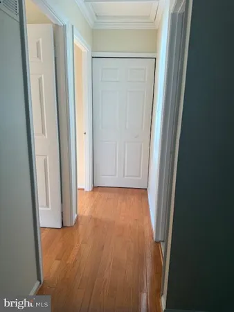 a view of hallway with wooden floor
