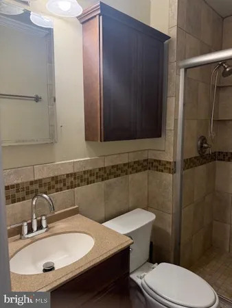 a bathroom with a sink a toilet and a shower