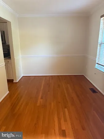 a view of a room with wooden floor and a window