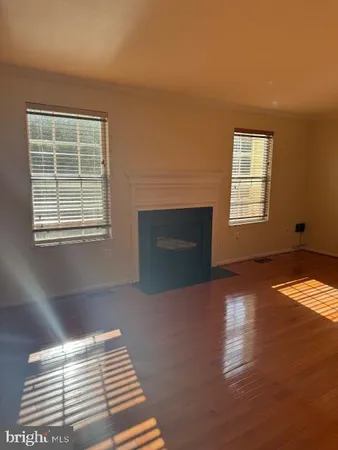 a view of empty room with window and fireplace