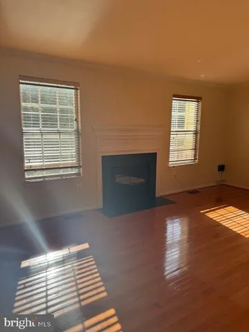 a view of empty room with window and fireplace