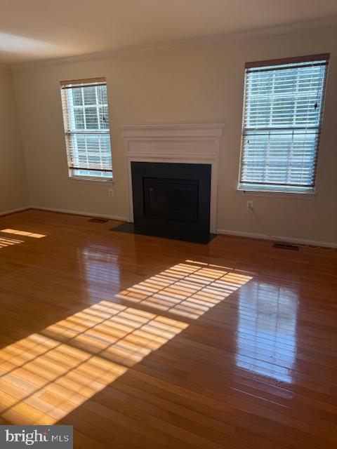 6358 Shaundale Drive Springfield, VA 22152 - Photo 9 of 54 a view of empty room with wooden floor and fireplace