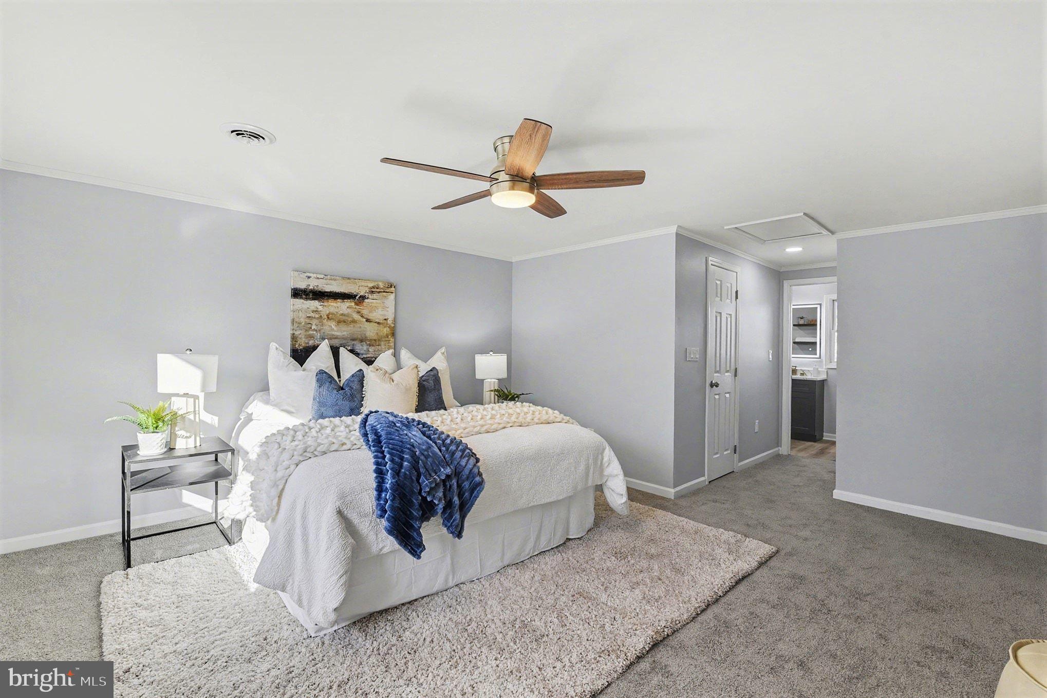1009 Maple Road Essex, MD 21221 - Photo 13 of 26 a spacious bedroom with a bed and ceiling fan