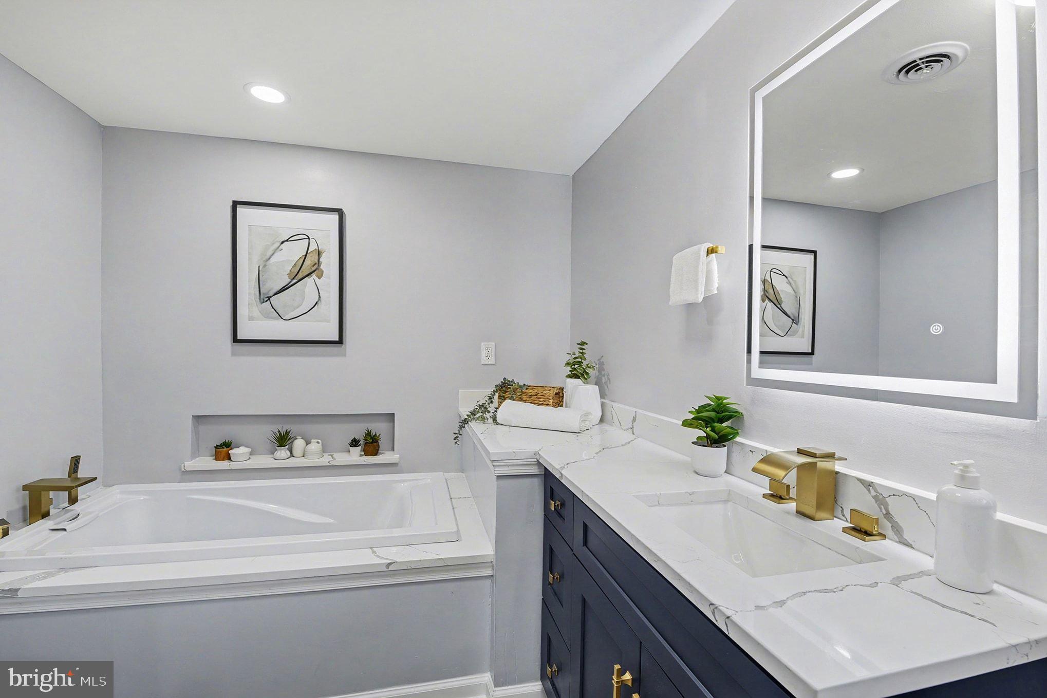 1009 Maple Road Essex, MD 21221 - Photo 14 of 26 a bathroom with a sink and a mirror