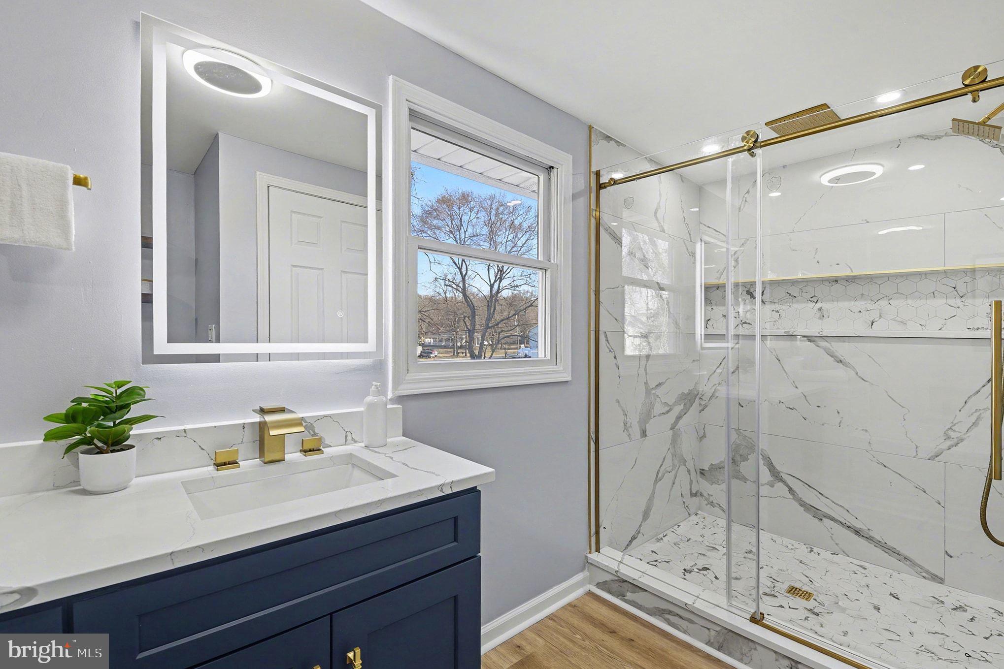 1009 Maple Road Essex, MD 21221 - Photo 15 of 26 a bathroom with a shower sink and mirror