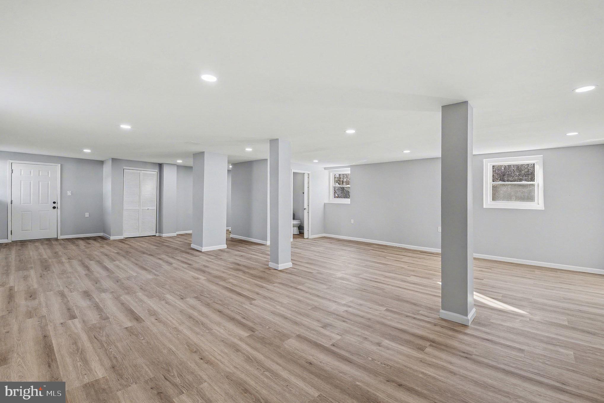 1009 Maple Road Essex, MD 21221 - Photo 20 of 26 a view of an empty room with wooden floor and a window