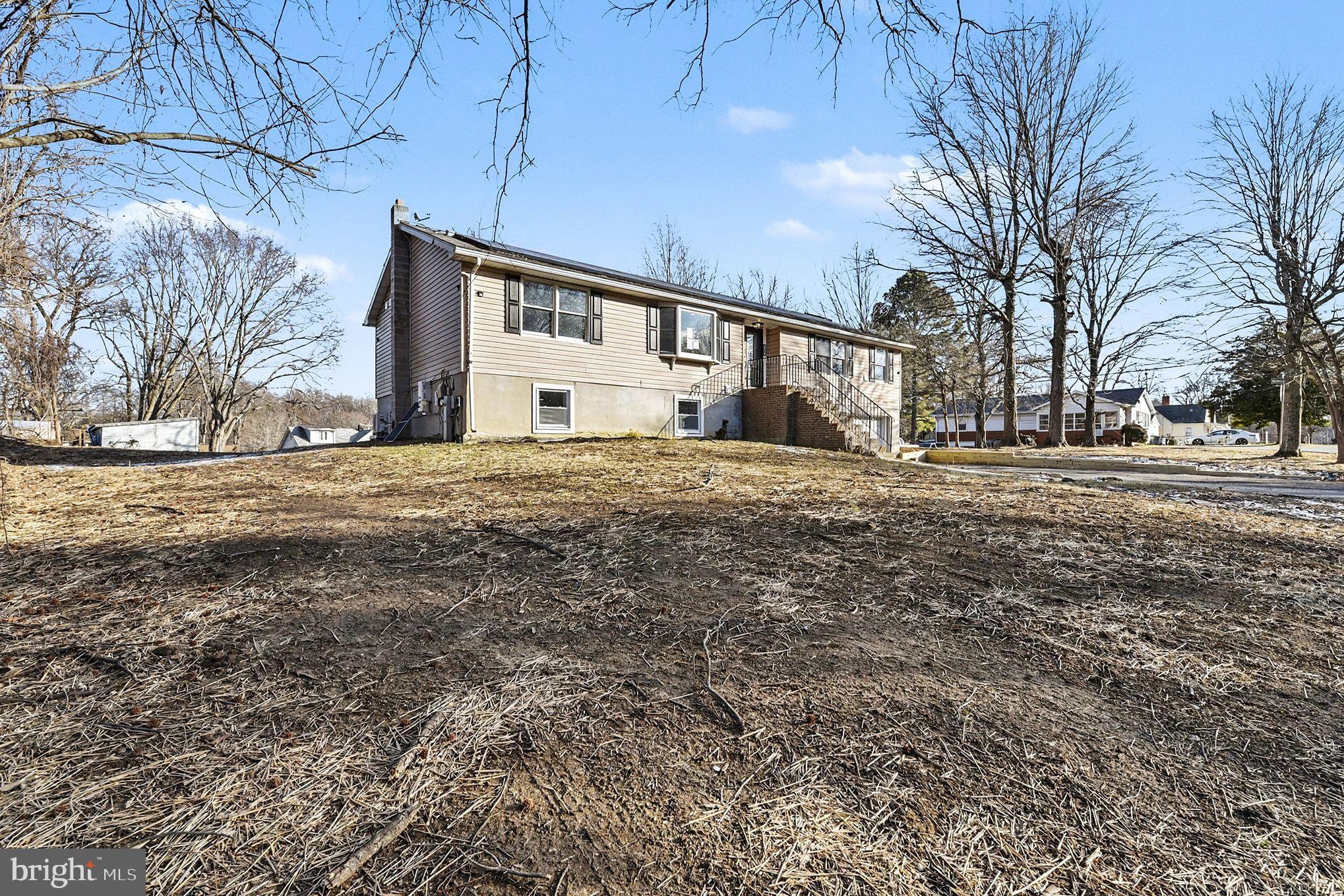 1009 Maple Road Essex, MD 21221 - Photo 25 of 26 a large white house with a large tree in front of it