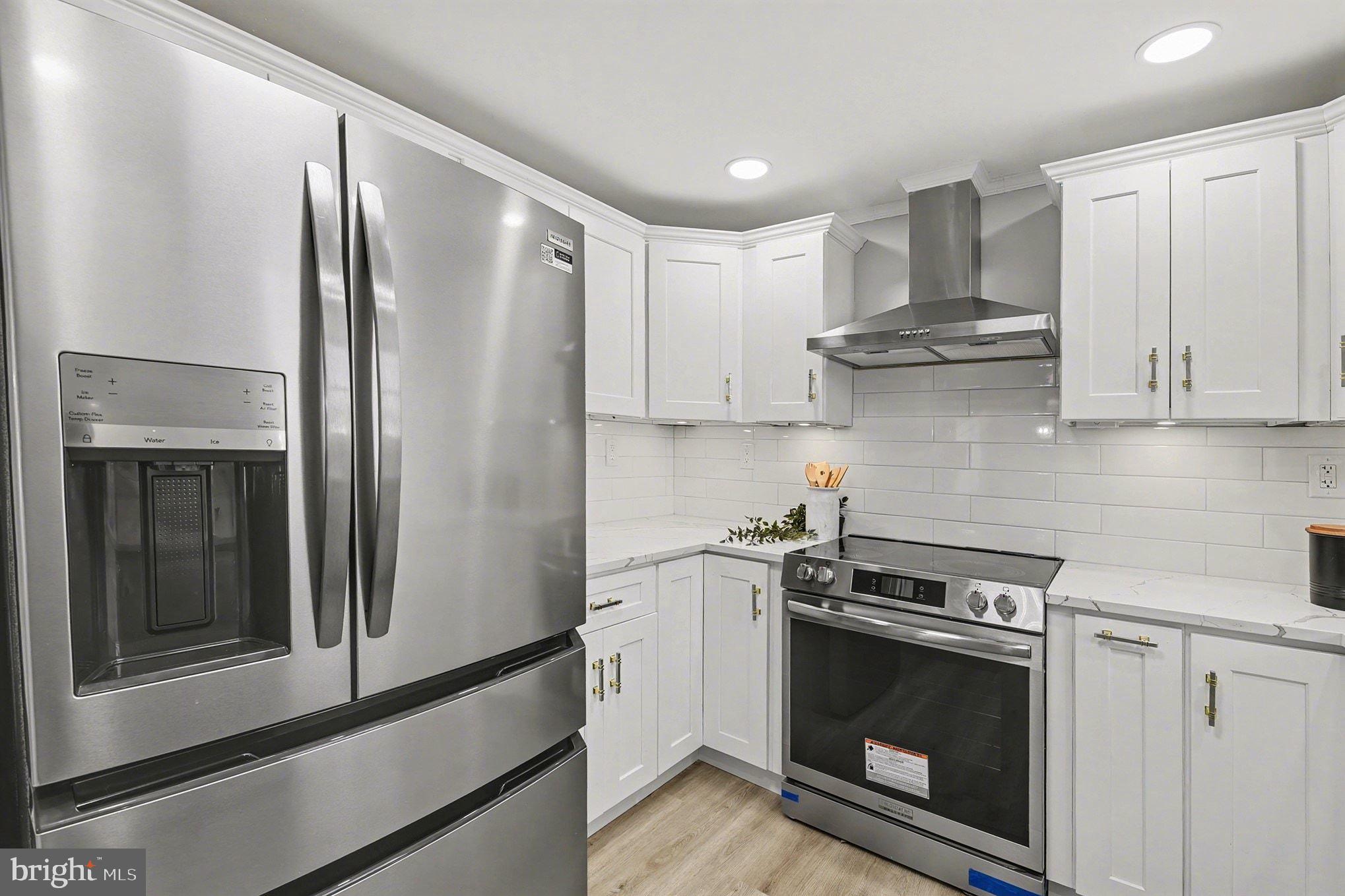 1009 Maple Road Essex, MD 21221 - Photo 3 of 26 a kitchen with stainless steel appliances a stove a microwave and a refrigerator