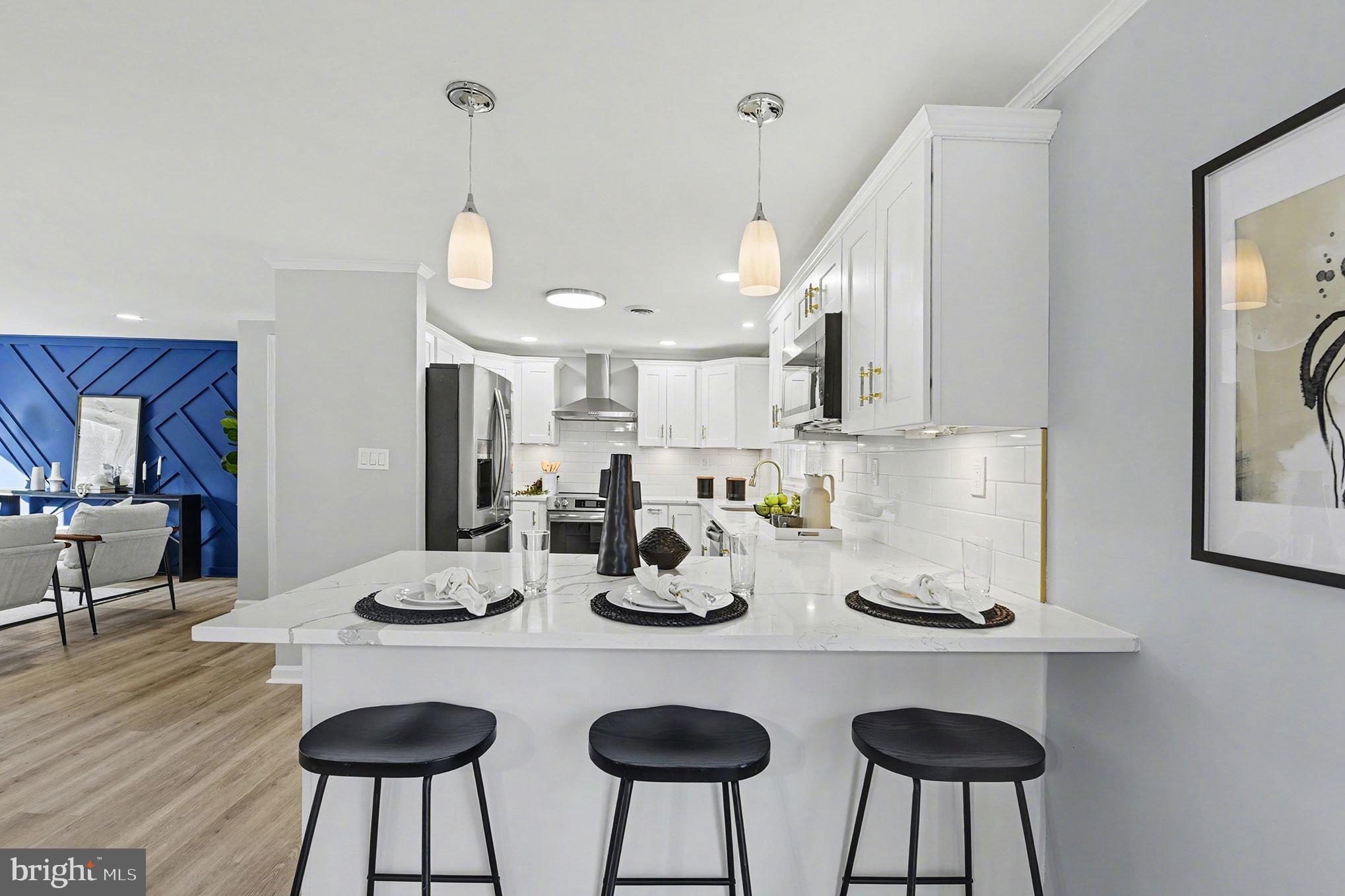 1009 Maple Road Essex, MD 21221 - Photo 6 of 26 a kitchen with sink a table and chairs