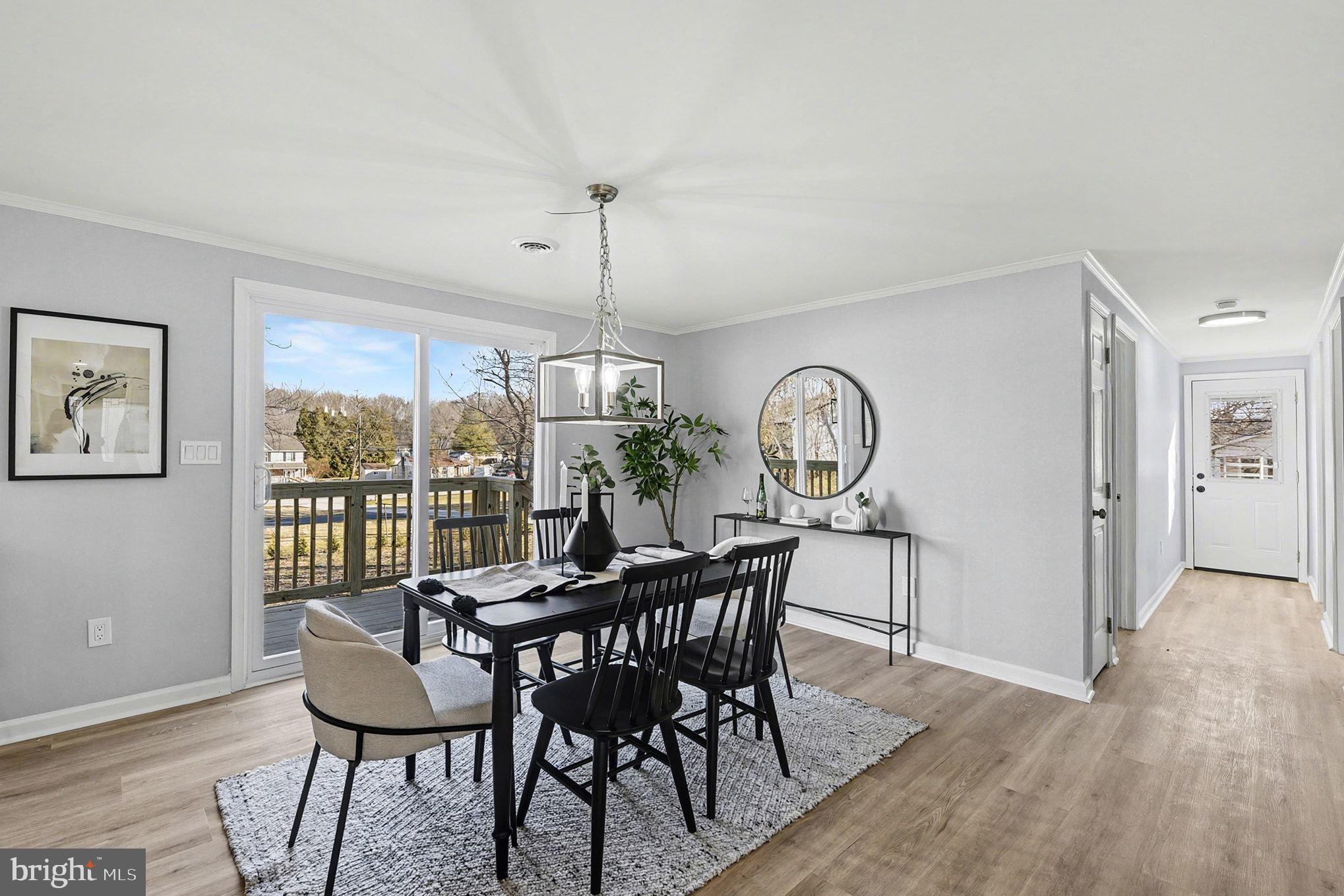 1009 Maple Road Essex, MD 21221 - Photo 7 of 26 a view of a dining room with furniture window and wooden floor