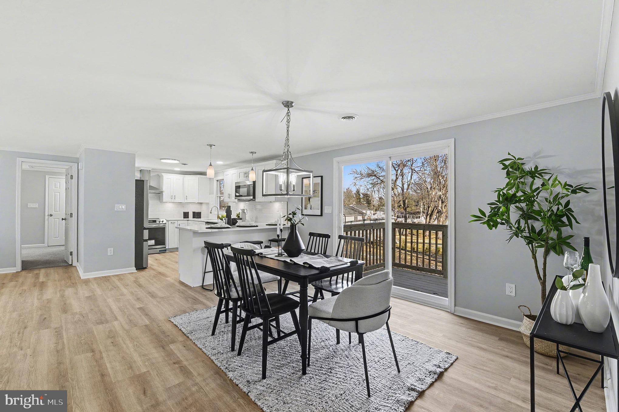 1009 Maple Road Essex, MD 21221 - Photo 8 of 26 a view of a dining room with furniture window and wooden floor