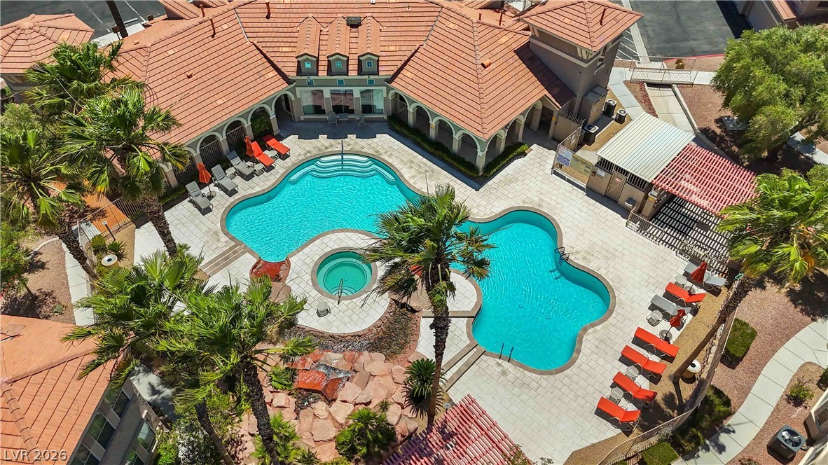 10550 West Alexander Road, Unit 2060 Las Vegas, NV 89129 - Photo 36 of 45 An aerial view captures the inviting pool area, complete with multiple lounging spaces and tropical palms.
