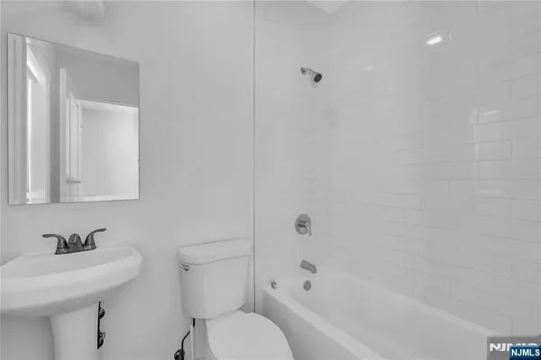 a bathroom with a sink toilet a mirror and shower