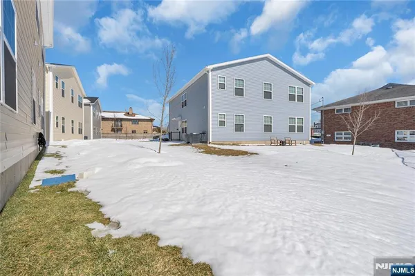 a view of a building with snow on the road