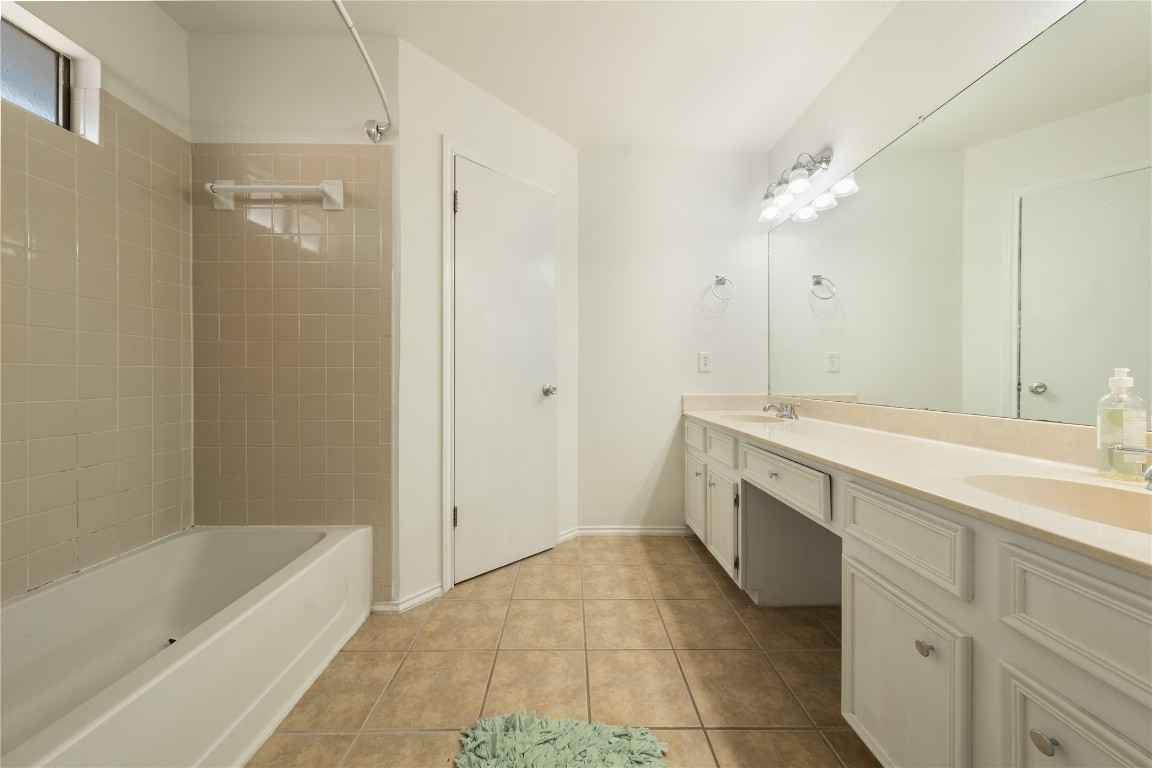 12900 Coridan Drive Austin, TX 78727 - Photo 12 of 16 a bathroom with a bathtub sink and mirror