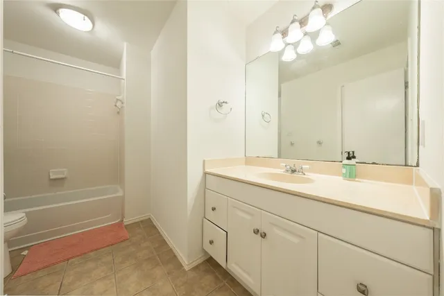 a bathroom with a tub sink and mirror