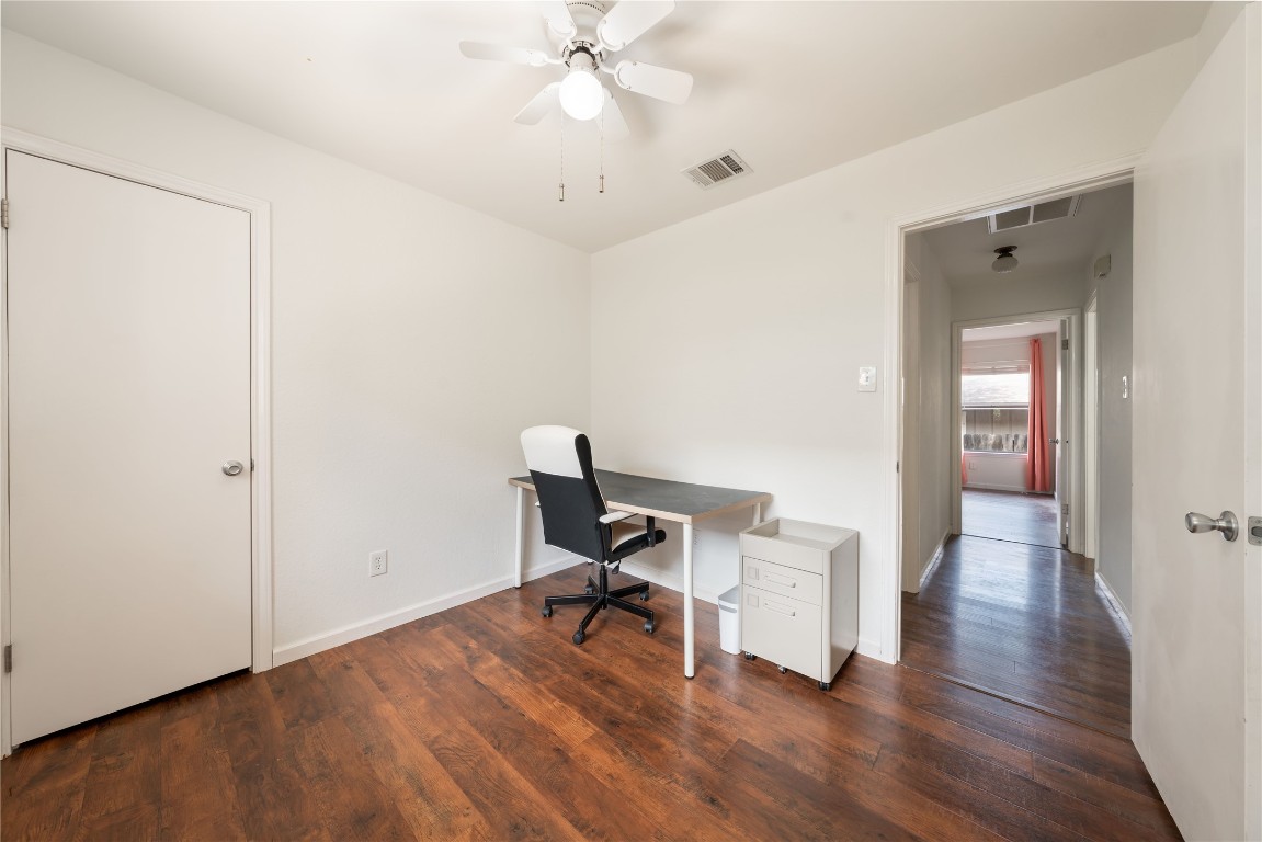 12900 Coridan Drive Austin, TX 78727 - Photo 10 of 16 a view of a workspace with furniture and wooden floor