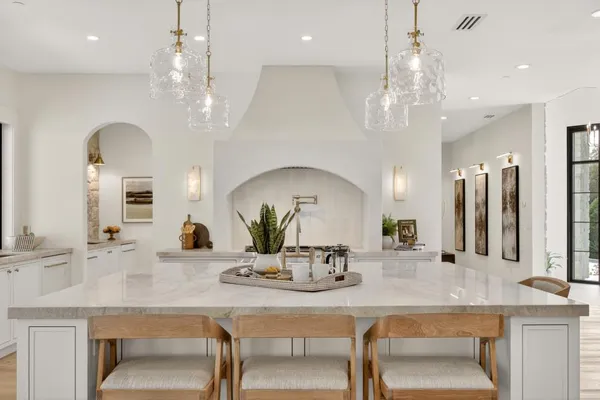 a view of a kitchen with wooden floor and cabinets