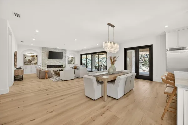 a living room with furniture plant and a large window