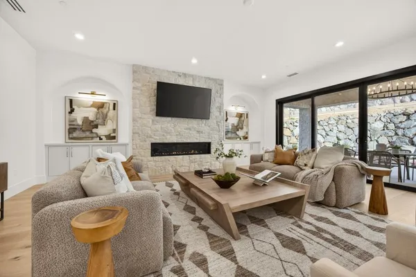 a hallway with white cabinets and wooden floor