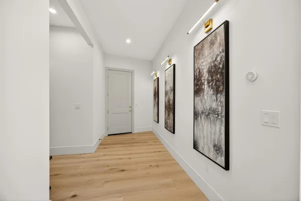 a bathroom with a sink a toilet and a large mirror