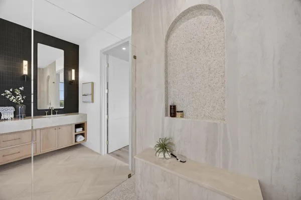 a bathroom with a double vanity sink a mirror and a bathtub