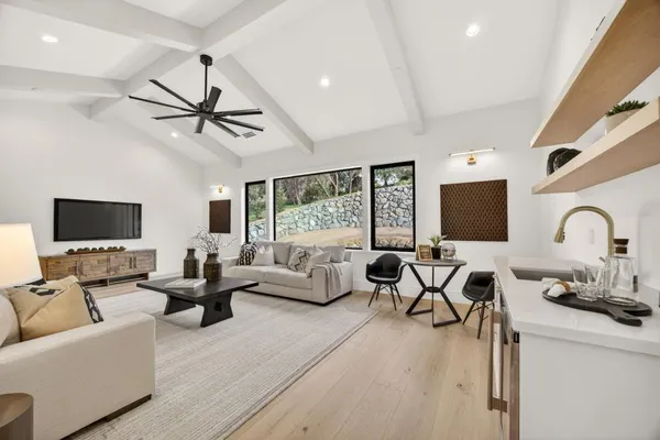 a view of a big house with a big yard and potted plants